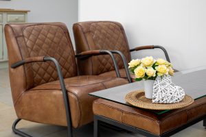 Brązowe meble skórzane w eleganckim salonie z kwiatową dekoracją