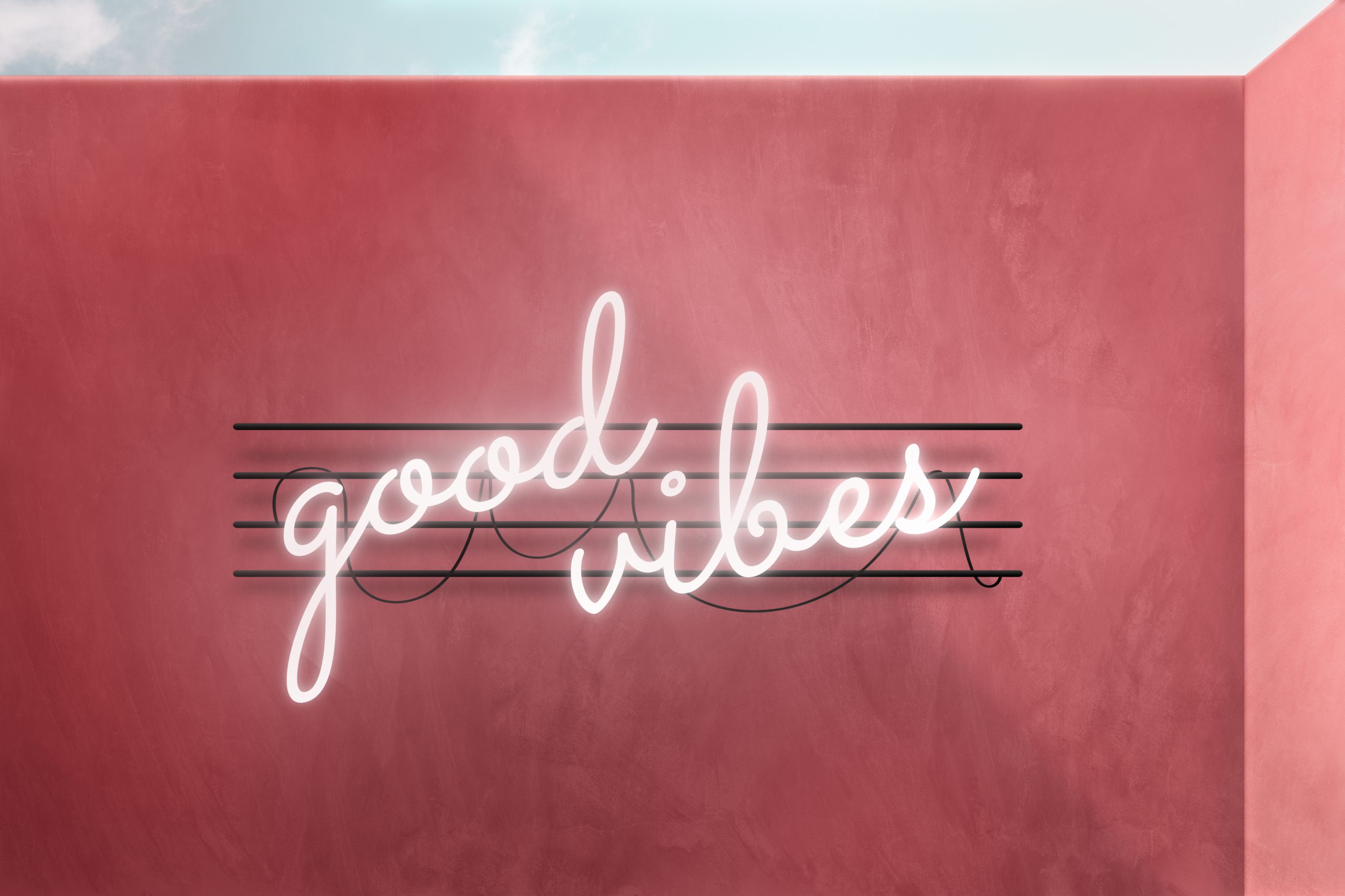 Dekoracyjne podświetlane logo na ścianę w formie jasnego neonu z napisem good vibes na różowym tle.